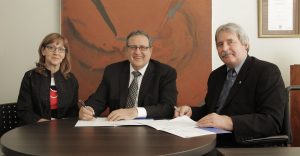 Human Resources Professionals Association chair Brenda Clark (left) and CEO Bill Greenhalgh (middle) sign a partnership agreement with Wolfgang Zimmerman, Executive Director, National Institute of Disability Management and Research (NIDMAR) and president, Pacific Coast University for Workplace Health Sciences (PCU-WHS). NIDMAR and PCU-WHS will be providing HRPA members with diagnostic and educational tools and resources to create accessible workplaces. (CNW Group/Human Resources Professionals Association of Ontario)